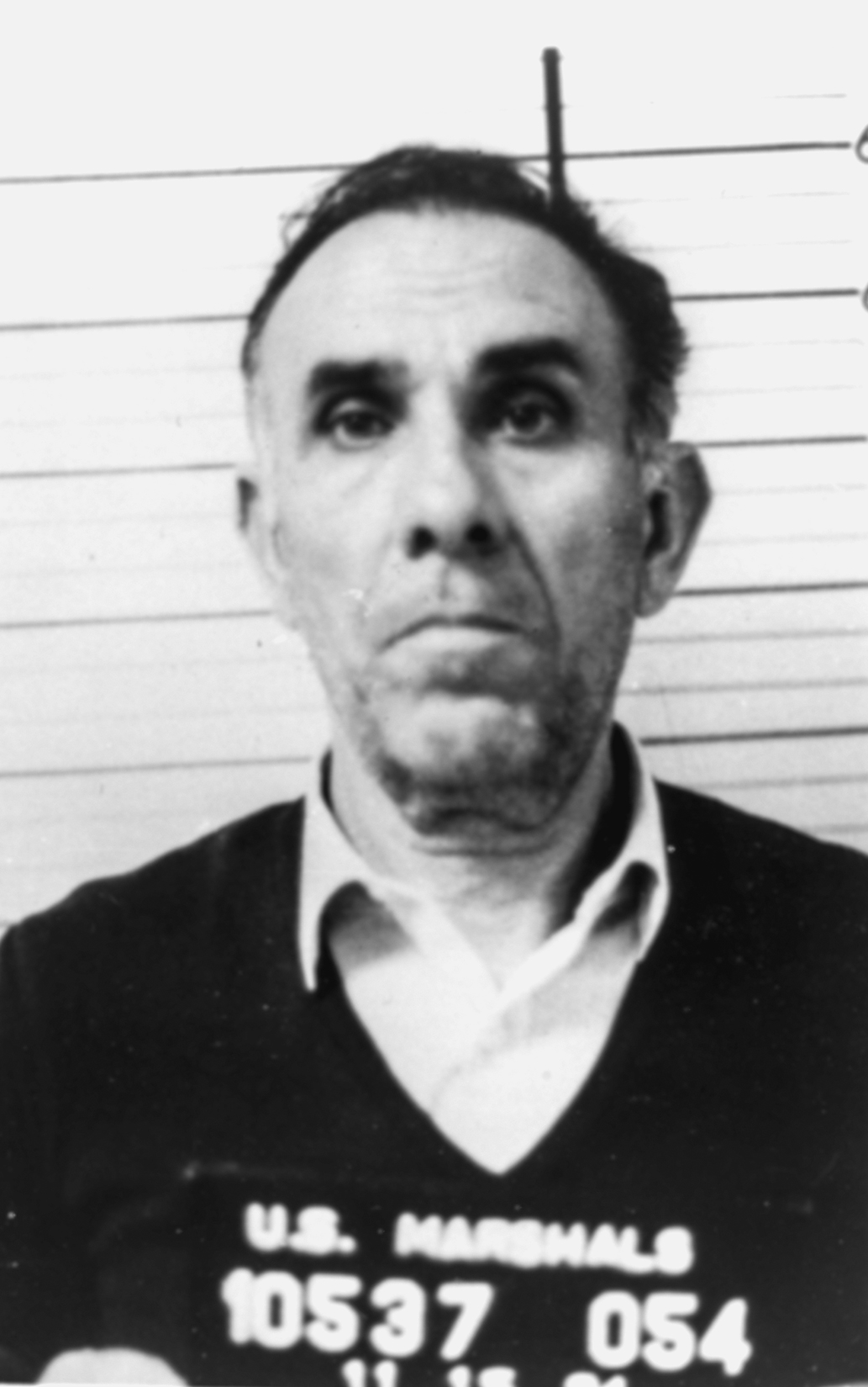1984 U.S. Marshals arrest photo of Gaetano Badalamenti: front view against a height chart, with a placard reading "U.S. Marshals 10537 054".