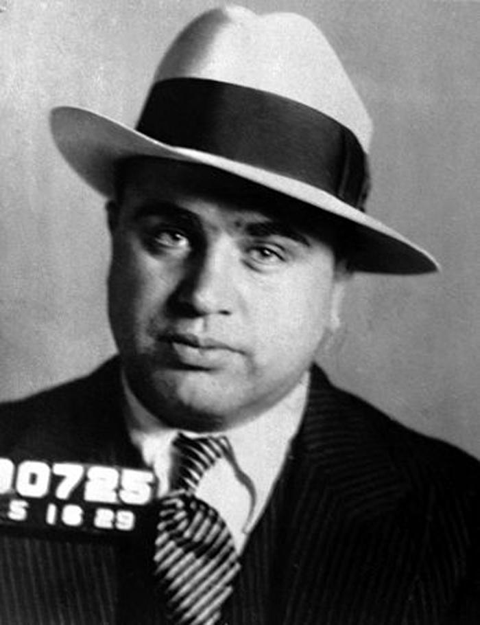 Mug shot of Al Capone, the lead image on the FBI's Al Capone history page: head and shoulders in a light fedora, striped tie and pinstripe suit, with a numbered placard.