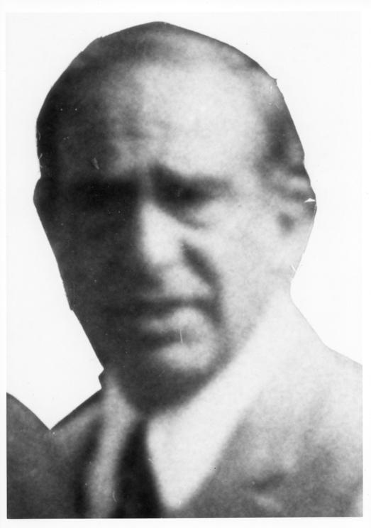 Carmine John Persico, Ten Most Wanted Fugitive #390: a blurred, enlarged head-and-shoulders photograph of a man in a jacket and tie, cut out against a white background.