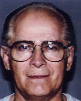 Top Ten fugitive James "Whitey" Bulger: head-and-shoulders color photograph of a man in glasses.