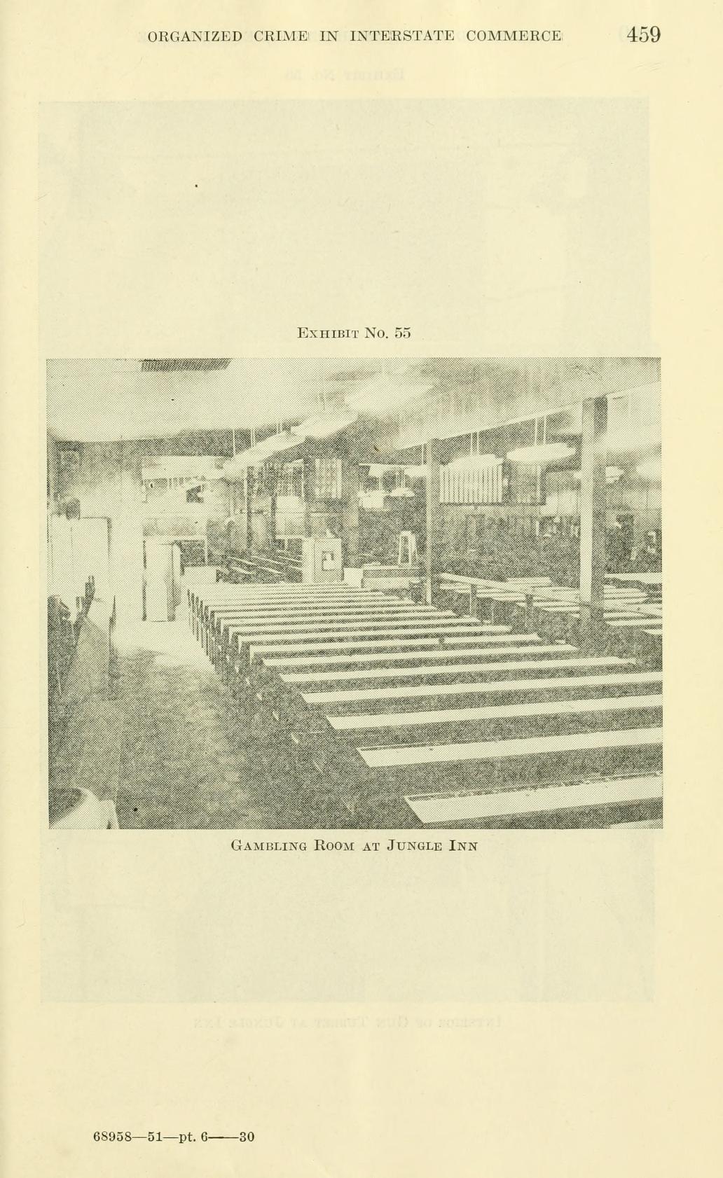 Exhibit No. 55, a photograph of a long room with rows of tables and chairs under hanging lights, captioned "Gambling Room at Jungle Inn".