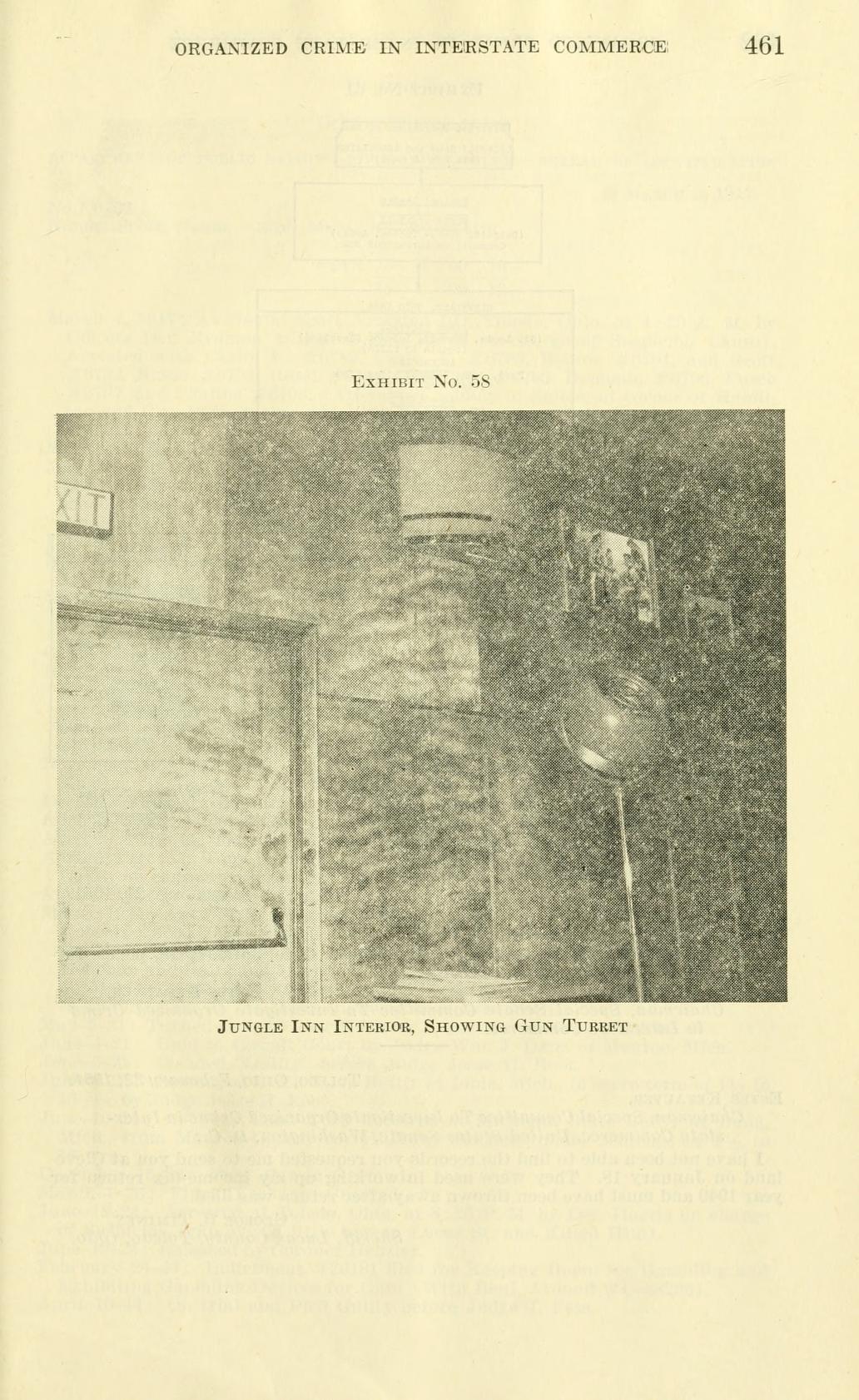 Exhibit No. 58, a photograph of an interior wall with a raised enclosure and a lamp, captioned "Jungle Inn Interior, Showing Gun Turret".
