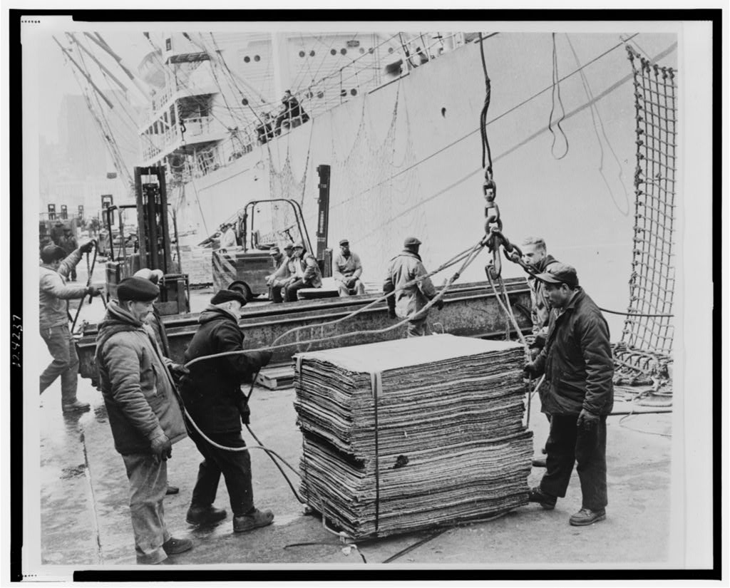 Longshoremen loading cargo onto a ship at a Brooklyn pier.