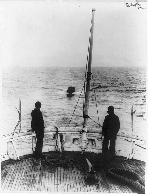 A view from the stern of the Coast Guard cutter Seneca showing the captured rum-runner in tow.