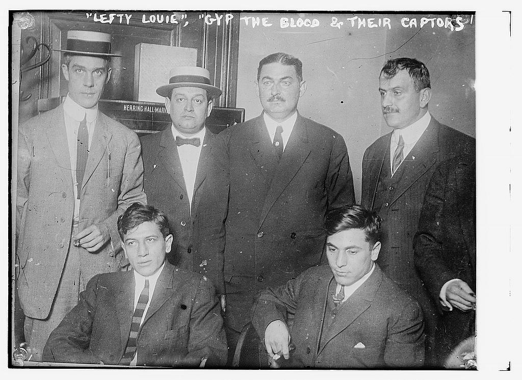 Two prisoners with the men who arrested them, Bain News Service photograph, 1912.