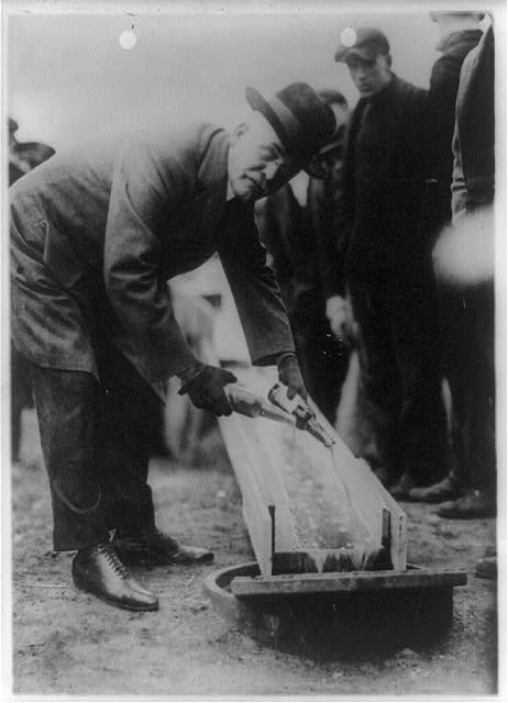 The mayor of Zion City, Illinois, pouring out two bottles of beer.