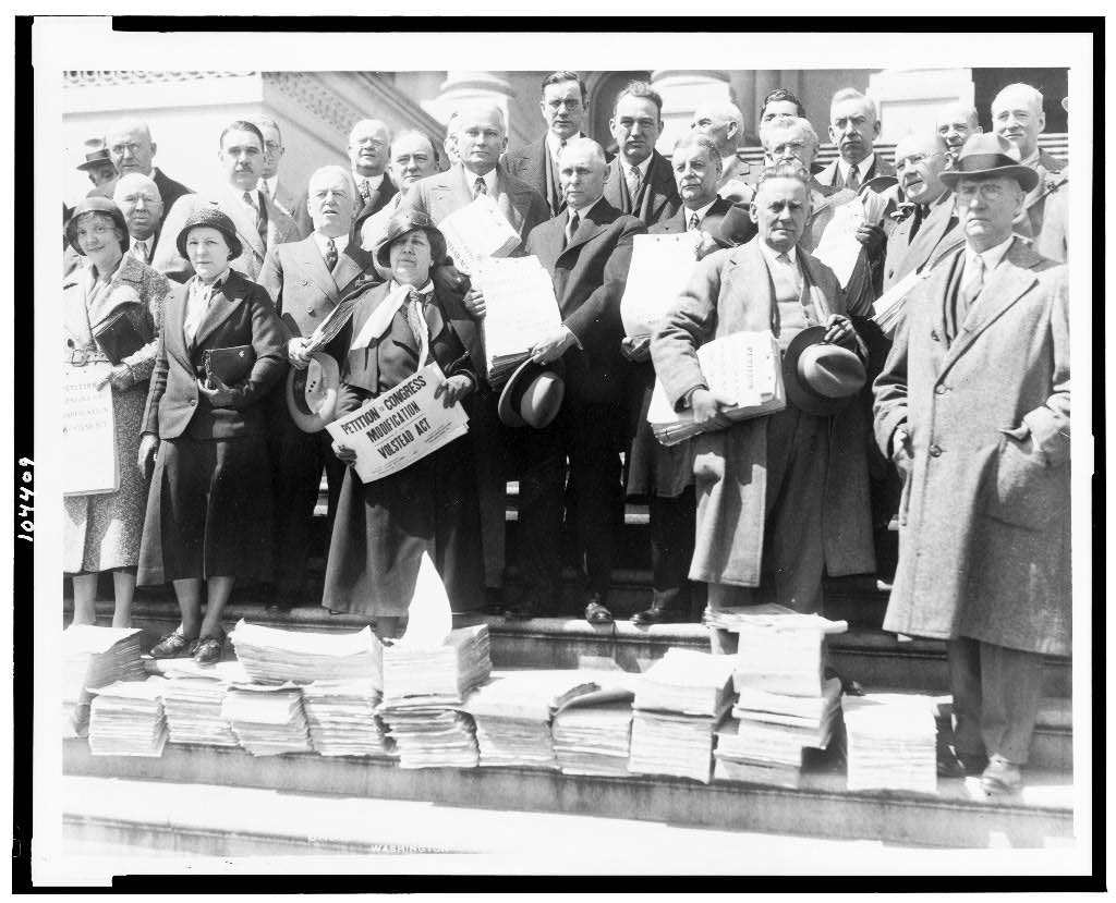 Members of the Congressional Districts Modification League and members of Congress with a huge petition.