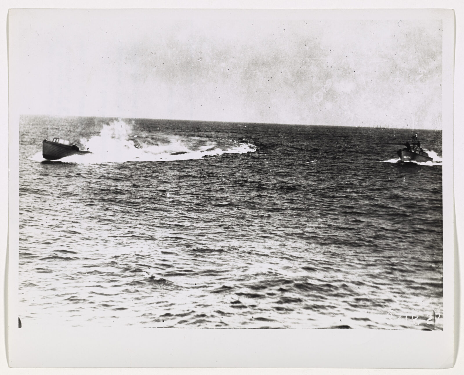 A Coast Guard picketboat firing on a rum-running vessel at sea.